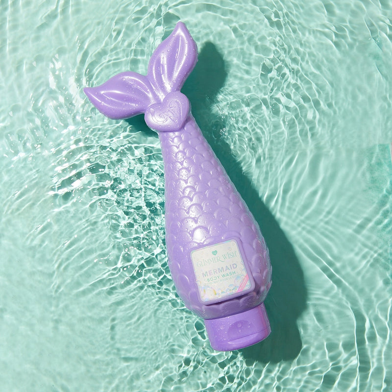 Purple mermaid-shaped bottle with a label on a light blue water background