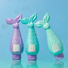 Mermaid Conditioner bottles in aqua, pink, and lavender shades displayed together on teal background.