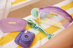 Mermaid Shell Cosmetics Bag displayed with matching mermaid-themed beauty accessories on a colorful towel.