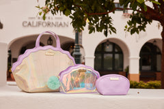 Mermaid Shell Cosmetics Bag shown outdoors with matching travel accessories and mermaid-themed products.