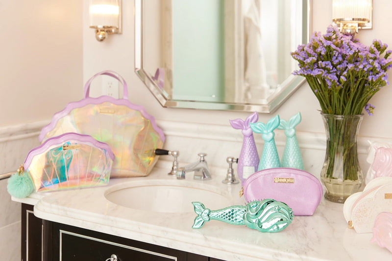 Mermaid Shell Cosmetics Bag placed on vanity beside mermaid hair products and decor.