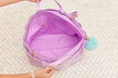 Inside view of Mermaid Shell Overnight Bag displaying roomy storage space and lavender lining.