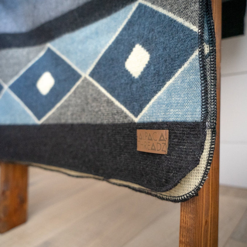 Close-up of the Midnight Blue & Grey Blanket folded edge, highlighting the subtle color gradients of the cool-toned stripes.