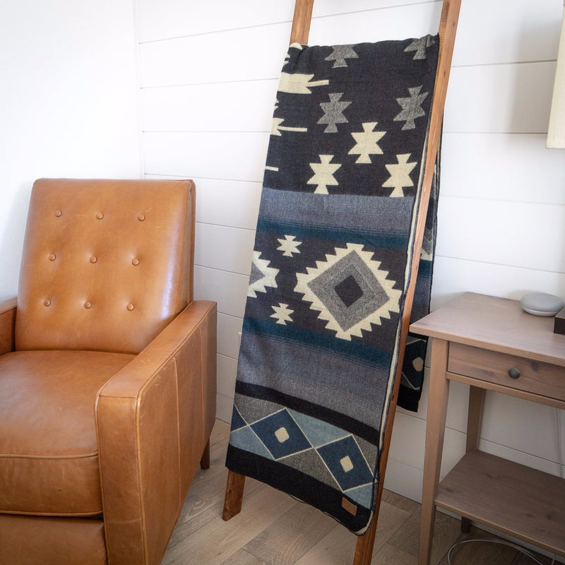 Midnight Blue & Grey Blanket draped vertically over a wooden ladder or chair back as an interior accent piece.