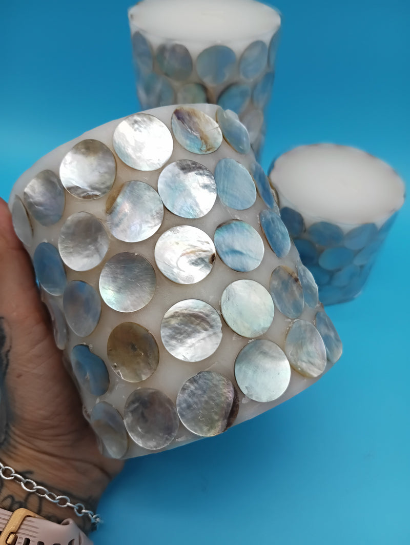Add seaside elegance with mother of pearl shell accent candles. Available in 3 sizes, perfect for coastal home décor, gifts, or centerpieces.