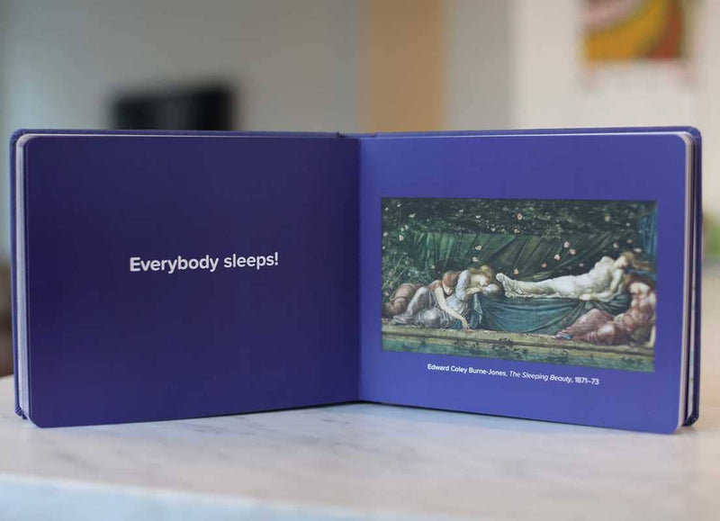 Open book with a purple cover displaying an illustration and text.