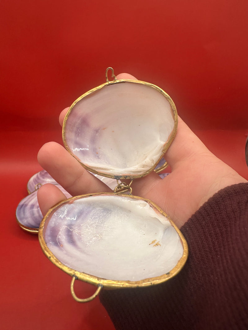 Open purple clam shell coin purse with metallic trim