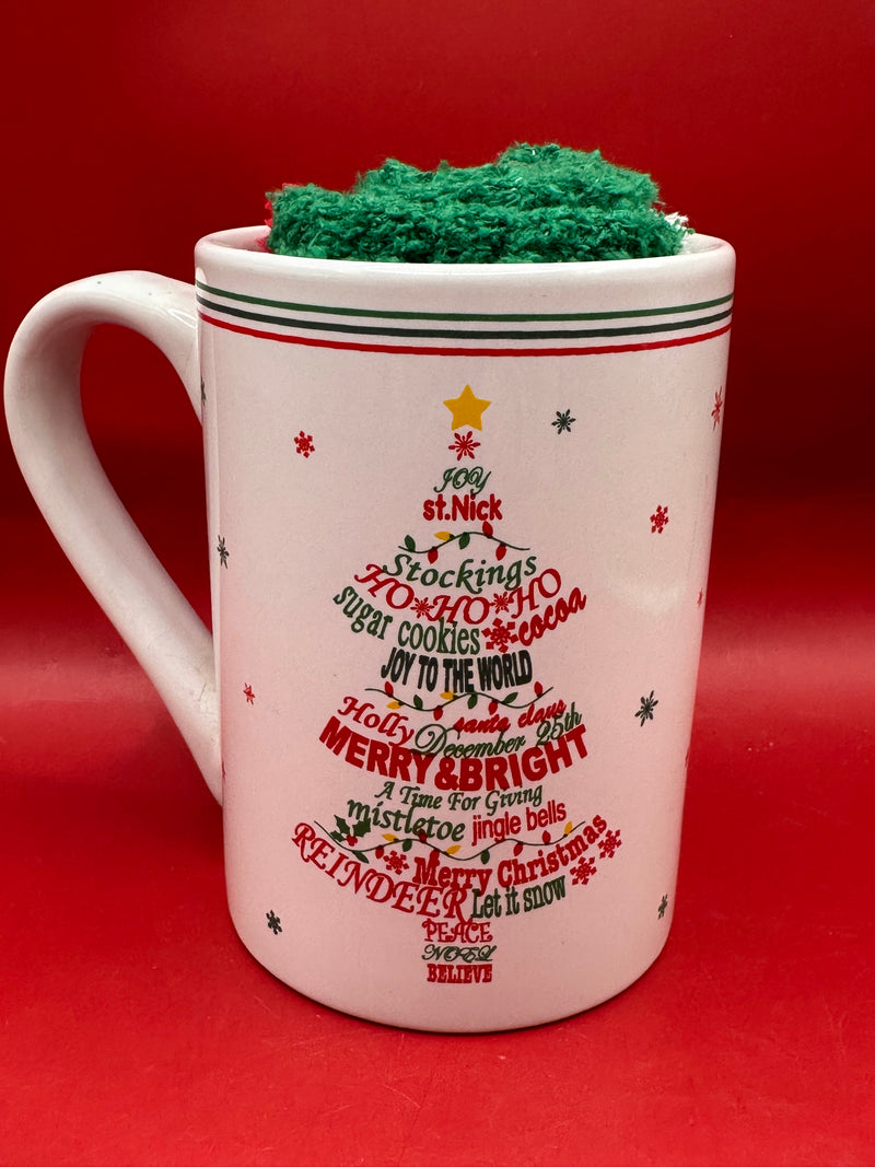 Ornament Christmas tree mug displayed beside fuzzy red and green holiday socks.