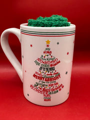 Ornament Christmas tree mug displayed beside fuzzy red and green holiday socks.