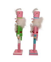 Two nutcrackers in pink and green outfits on a white background