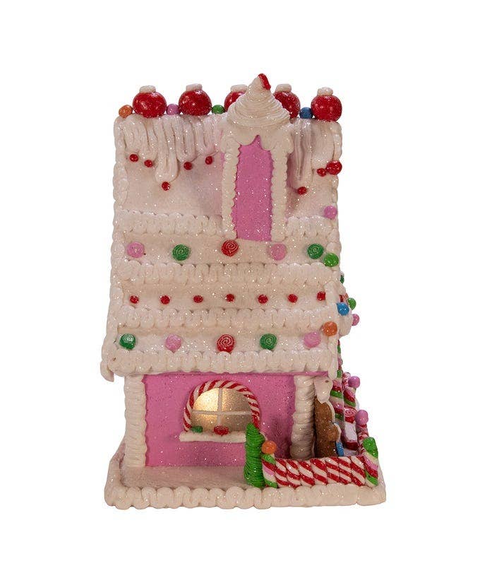 Decorative gingerbread house with candy decorations on a white background