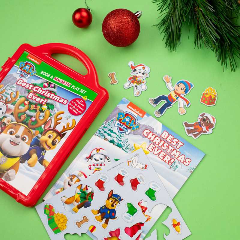 Paw Patrol Christmas play set with book, stickers, and magnetic elements on a green background.