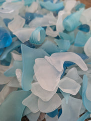 Hand-tumbled seaglass in various shapes and sizes with aqua, turquoise, and clear tones.