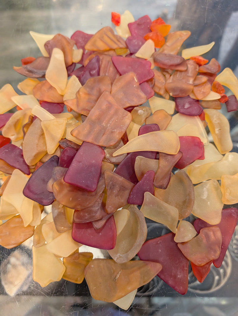 Collection of Hand Tumbled Seaglass pieces in sunset hues on a tabletop