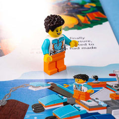 LEGO figure with a blue shirt and orange pants on a map