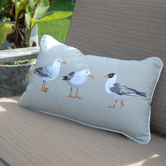 Seagull Pillow styled in a cozy patio setting, adding a touch of beachside whimsy to the decor.