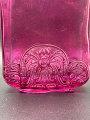 Close up of the design on the plum bottle. 