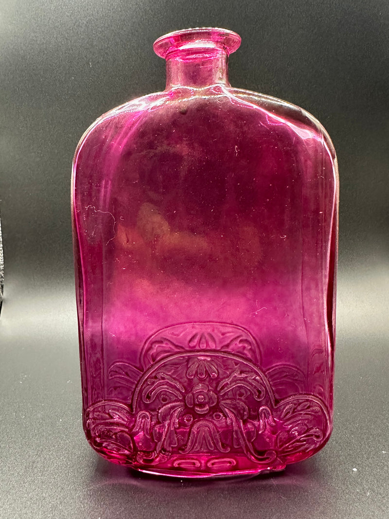 The Plum Bottle under a light.