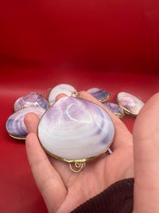 Purple clam shell coin purse in hand - 2.25