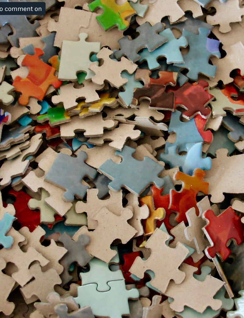 Close-up of Seaside Stars puzzle pieces scattered, highlighting intricate colors and details.