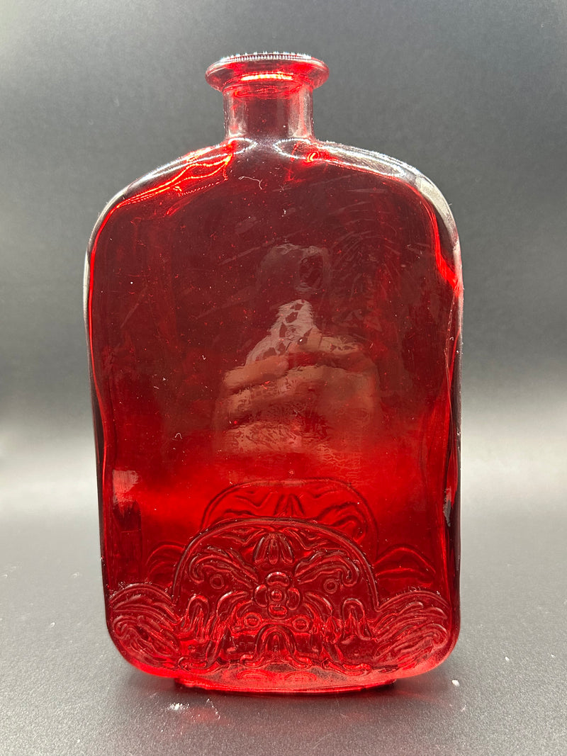 The Red Bottle under a light.