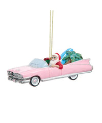 Christmas ornament of a pink Cadillac with Santa driving, on a white background