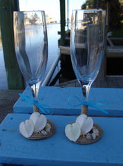 Rustic beach wedding champagne glasses decorated with twine, heart shells, sand dollars, starfish, and aqua ribbon bows
