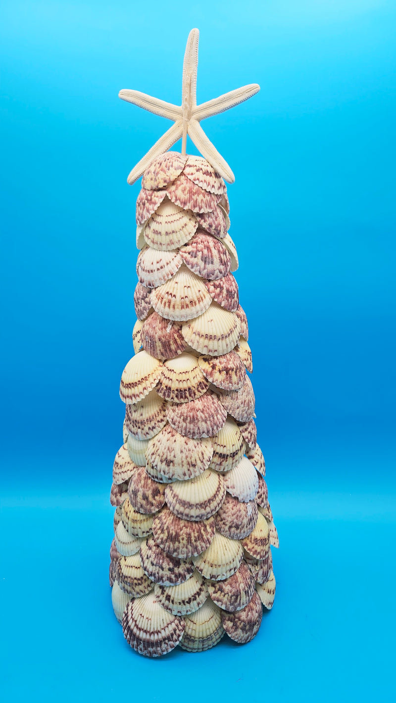 Center-focused view of the seashell tree, emphasizing the natural shell colors and the clean silhouette against the solid blue backdrop.