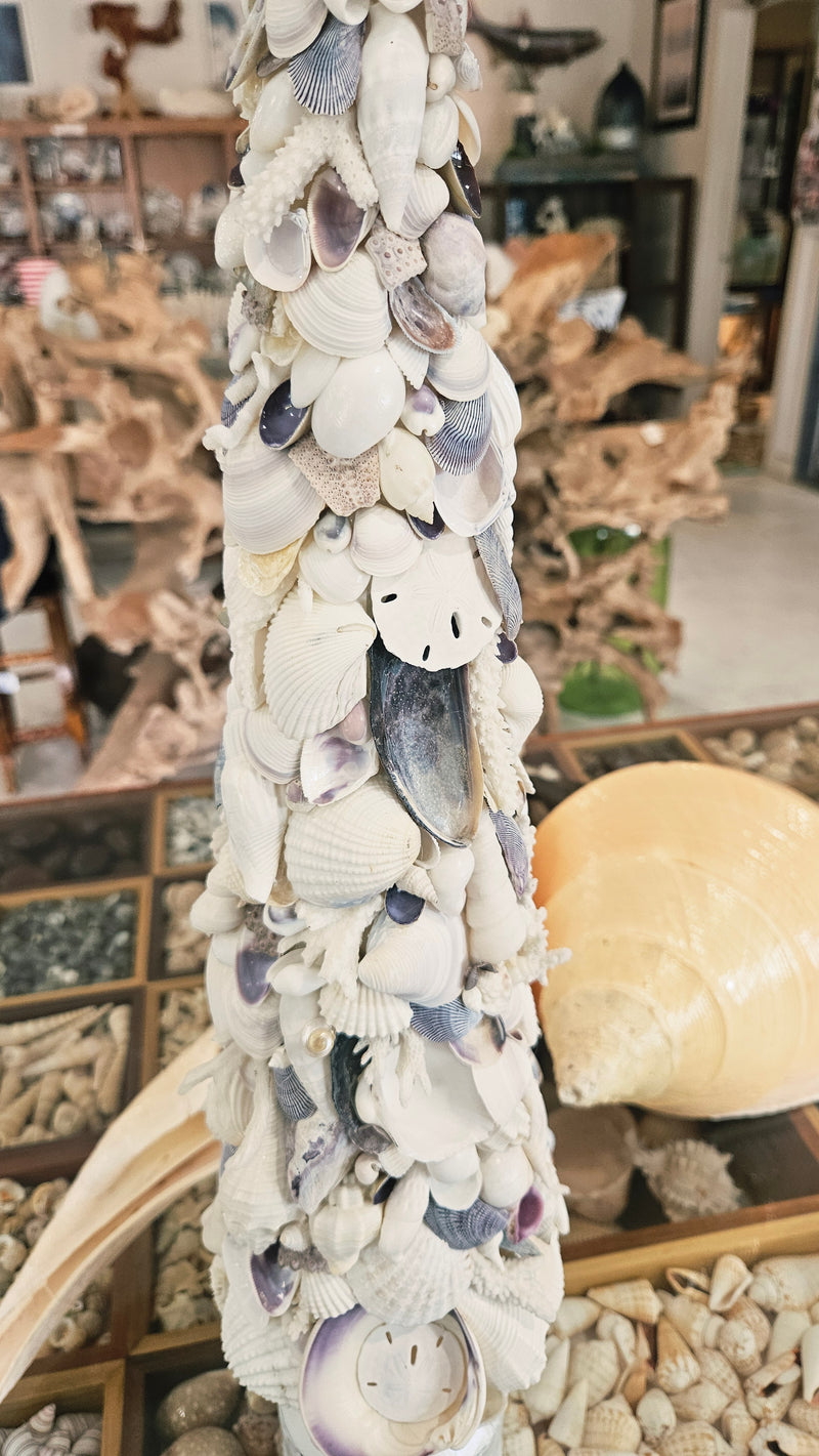 Detailed close-up of the upper half of the seashell tree, highlighting the lavender and white shells and the white starfish topper.