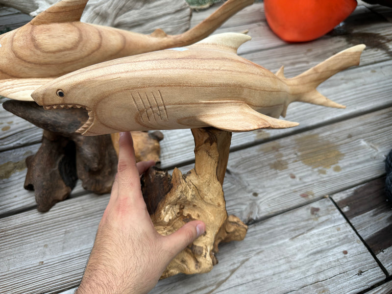 Hand holding a Large Driftwood Sculpture in the shape of a shark, detailed view