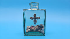 Shell-filled glass jar with bronze cross accent – inspirational beach house decor