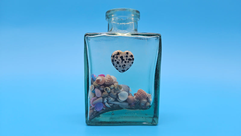 Shell-filled glass jar with white heart – romantic beach home decor