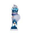 Small figurine of a character with a blue hat and white outfit on a stand.