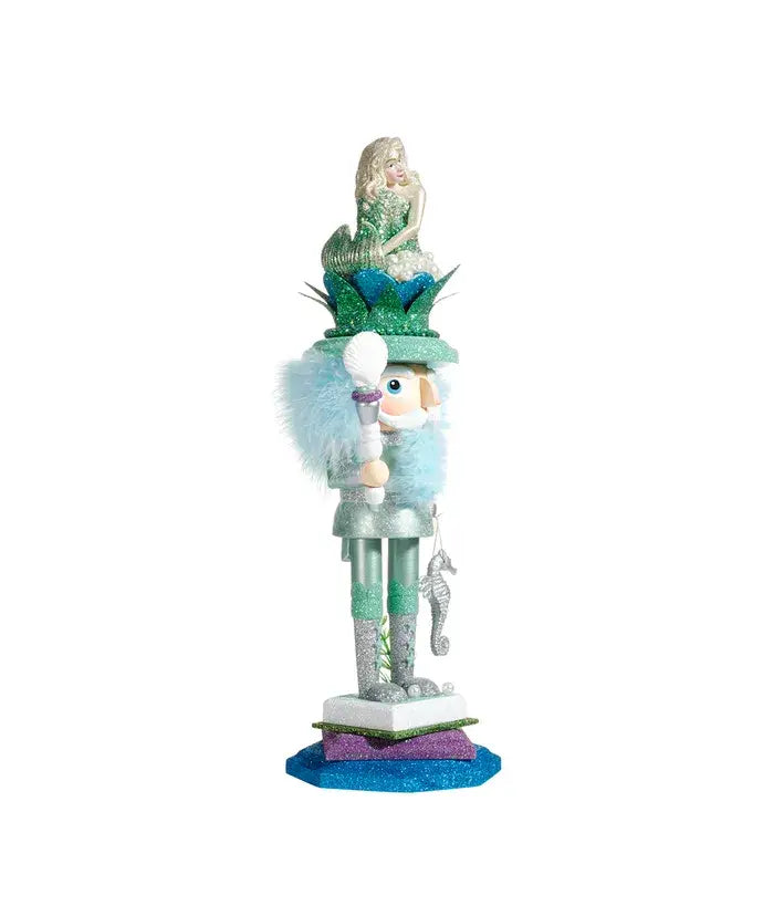 Side view of mermaid king nutcracker with mermaid crown and shell scepter