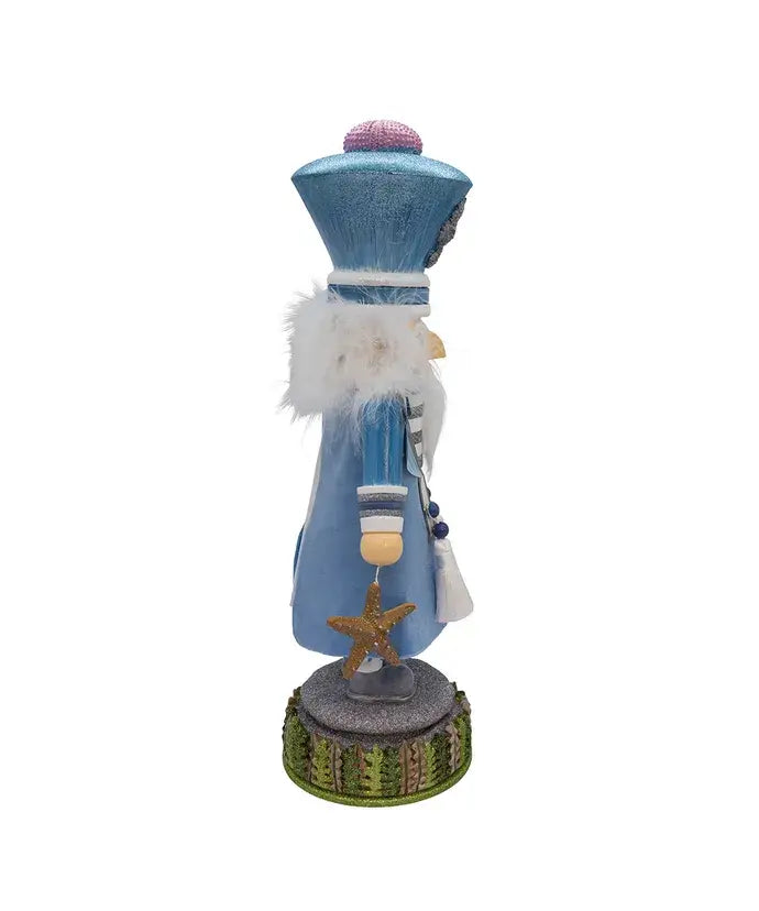 Decorative figure with blue outfit and starfish on a white background