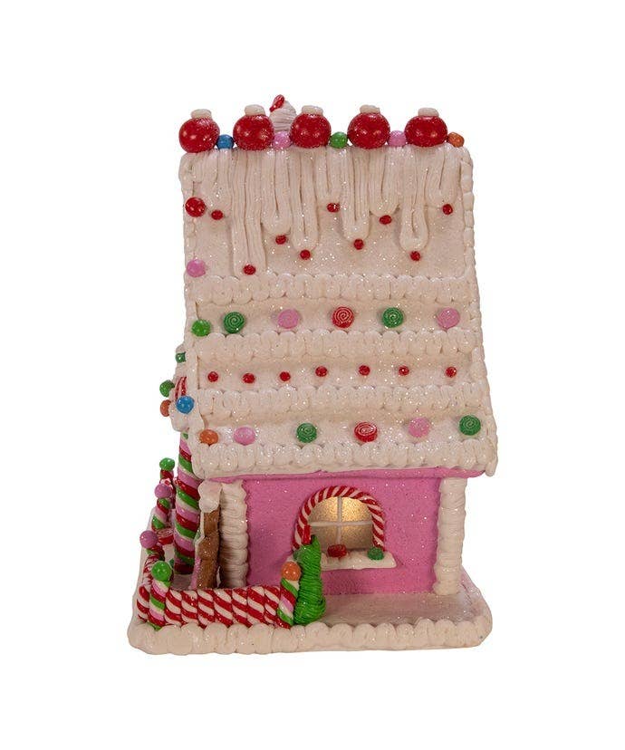 Decorative gingerbread house with candy details on a white background