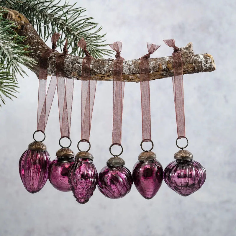 Small mixed design 1" mulberry crackle glass baubles, hand-blown with a cracked glaze, hanging on a branch.