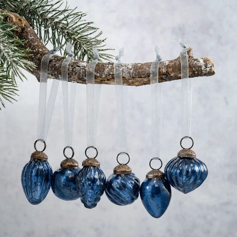 Small mixed design 1" old navy crackle glass baubles, hand-blown with a cracked glaze finish, hanging on a branch.