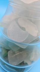 Layered sea glass display in glass Christmas tree – ocean inspired holiday décor