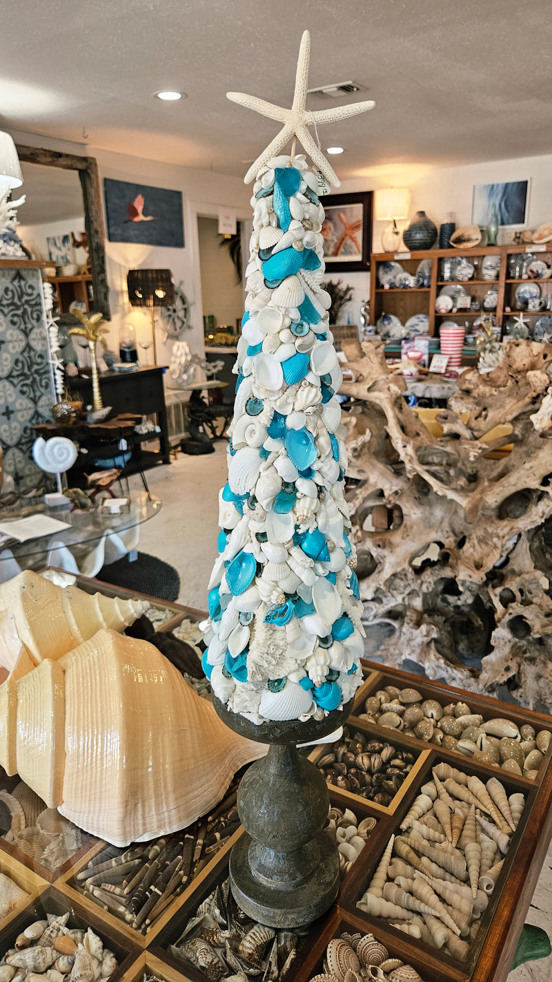 Turquoise and white seashell Christmas tree, showing its full height and the natural white starfish topper.