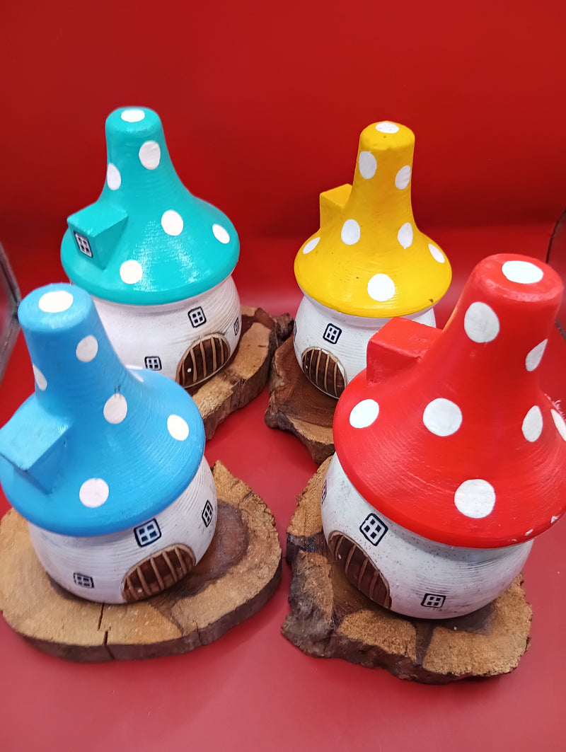 Wooden mushroom house accents with teal, yellow, red, and blue roofs on rustic wood bases – front display view