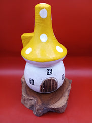 Wooden mushroom house accent with yellow polka dot roof and rustic wood base – garden decor