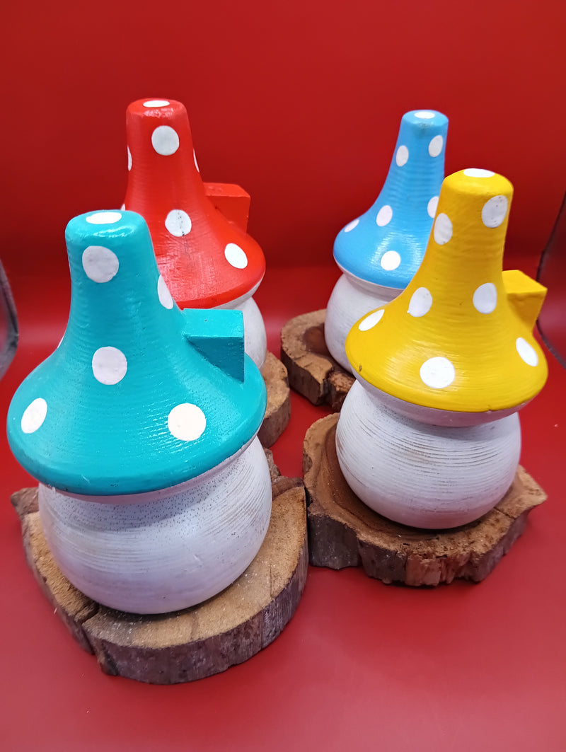 Set of four wooden mushroom house accents with teal, yellow, red, and blue roofs on wood bases – back view