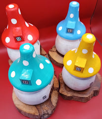 Wooden mushroom house accents in teal, yellow, red, and blue with polka dot roofs on wood bases – top angle view