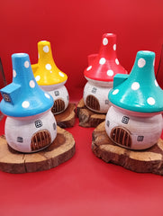 Wooden mushroom house accents with teal, yellow, red, and blue roofs on rustic wood bases – front display view