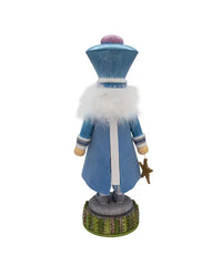 Decorative figure of a character in a blue coat with white fur trim on a white background