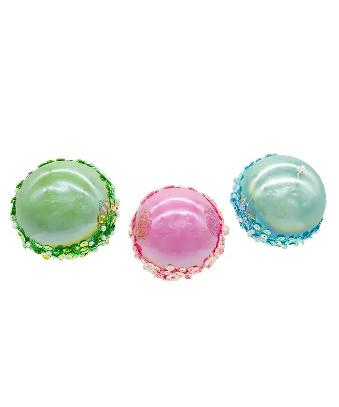 Three colorful bottom of Christmas ornaments on a white background