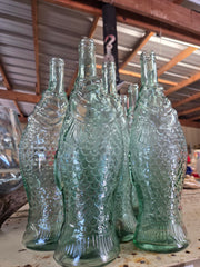 Light green vintage fish-shaped glass bottle