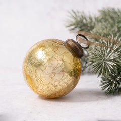 Gold crackle glass Christmas bauble with bronze cap and organza ribbon.