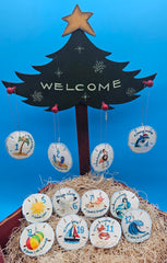 Handcrafted seaside sand dollar ornaments with coastal 12 Days of Christmas designs – nautical Christmas decor